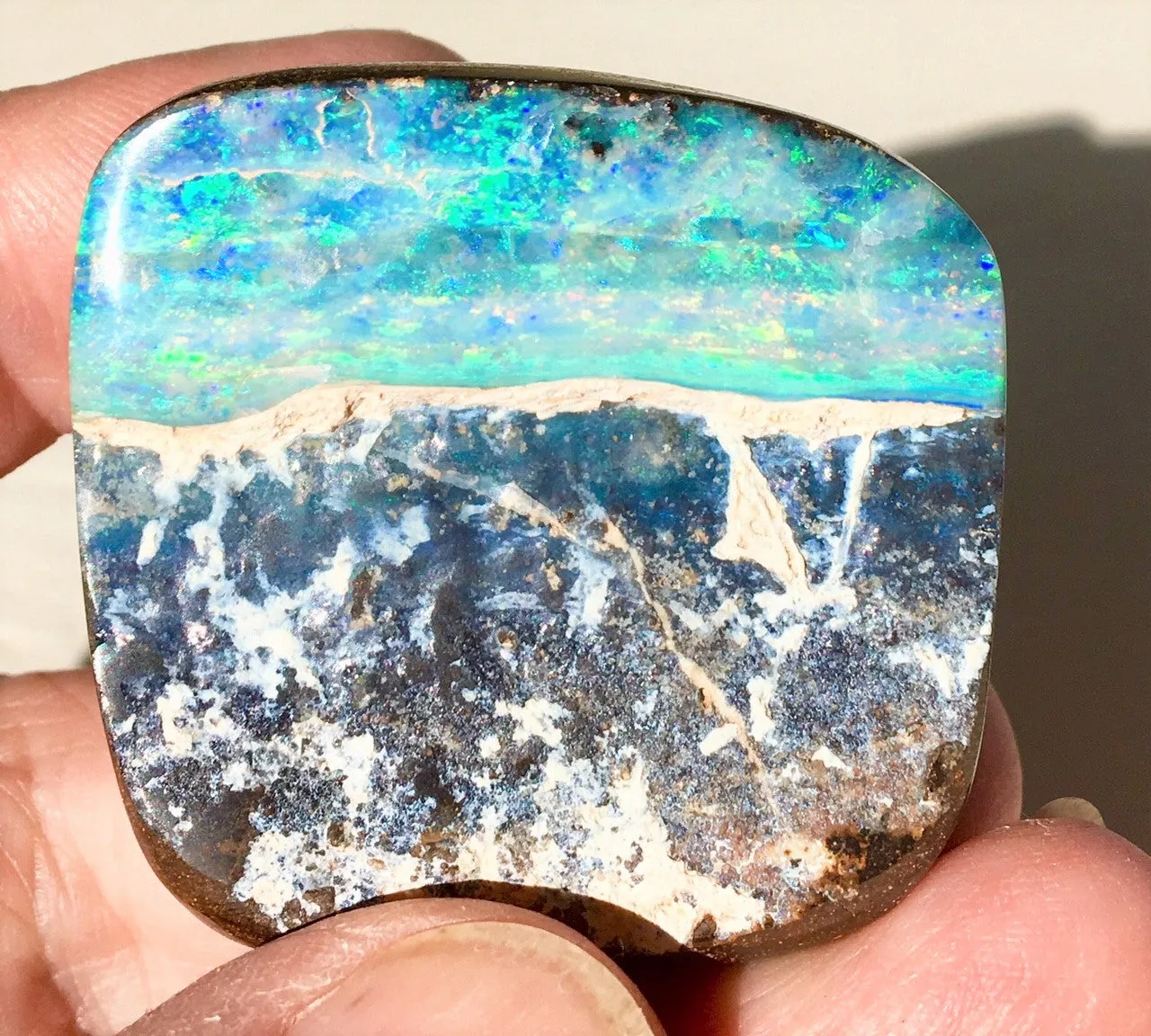 Multi Coloured boulder opal polished speciman